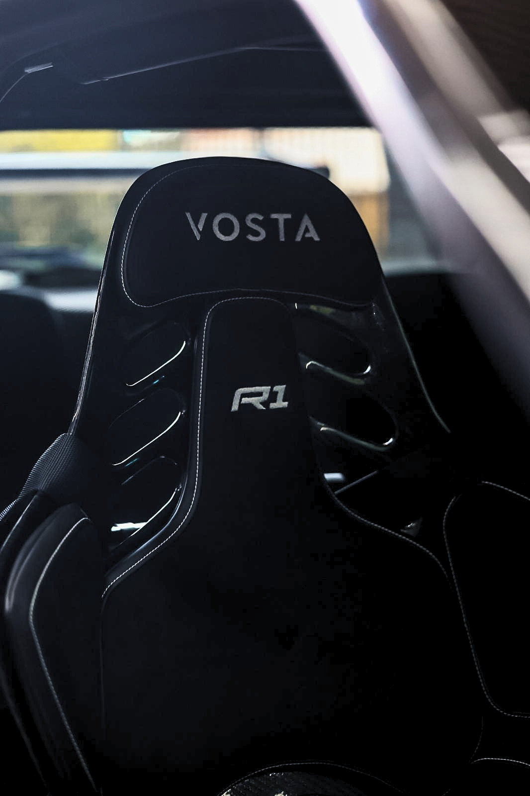 VOSTA R1 fixed back racing seat installed inside the Nissan Skyline R34 GT R, designed for lightweight performance and driver support.